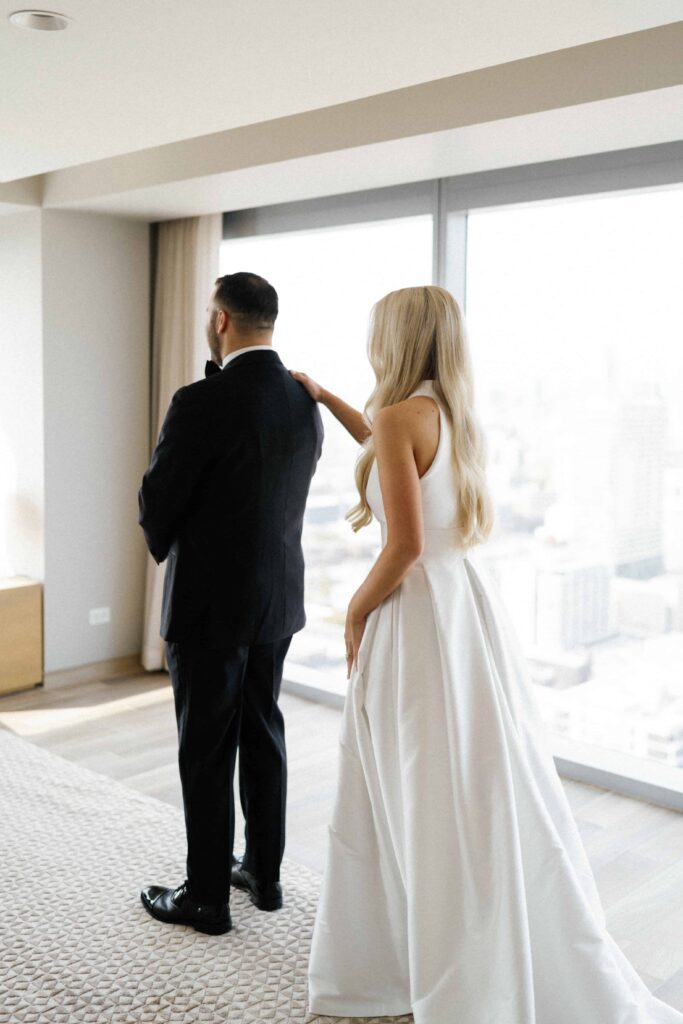 Bride and groom first look wedding photos at their Chicago hotel.