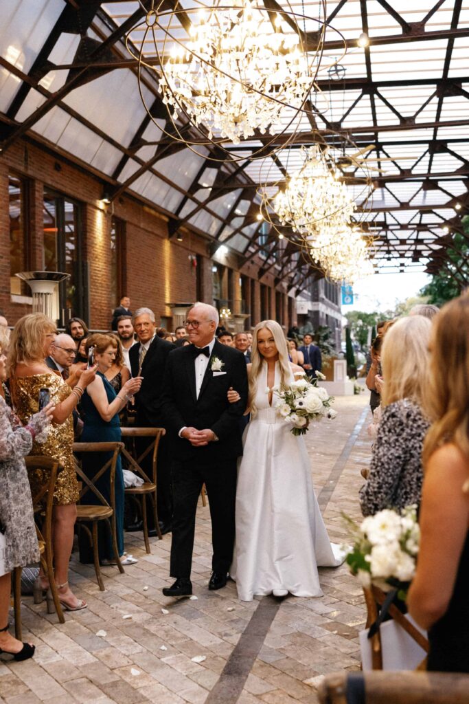 Bride walked down the aisle in the Sculpture Garden at Bridgeport Art Center.