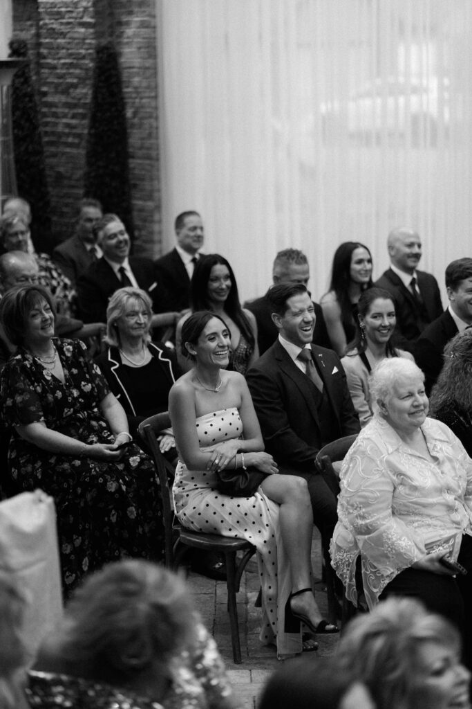 Wedding guest candid moment at the Sculpture Garden in Bridgeport Art Center.