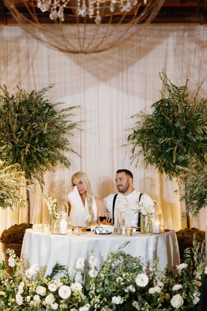 Bride and groom at sweetheart table during their reception at Bridgeport Art Center.