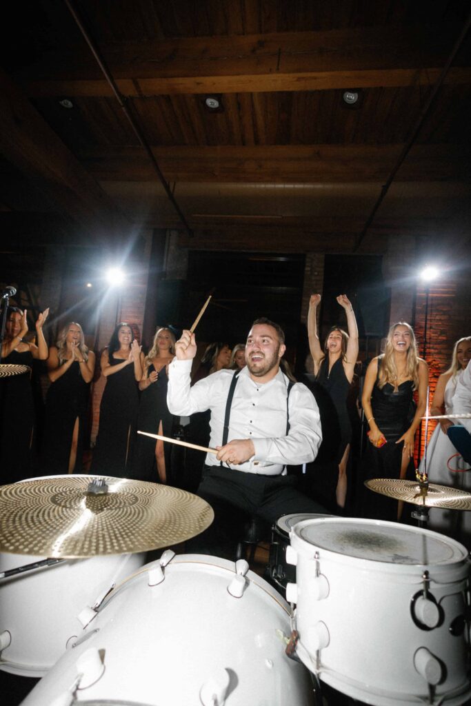 Groom playing drums in the Skyline Loft at Bridgeport Art Center.