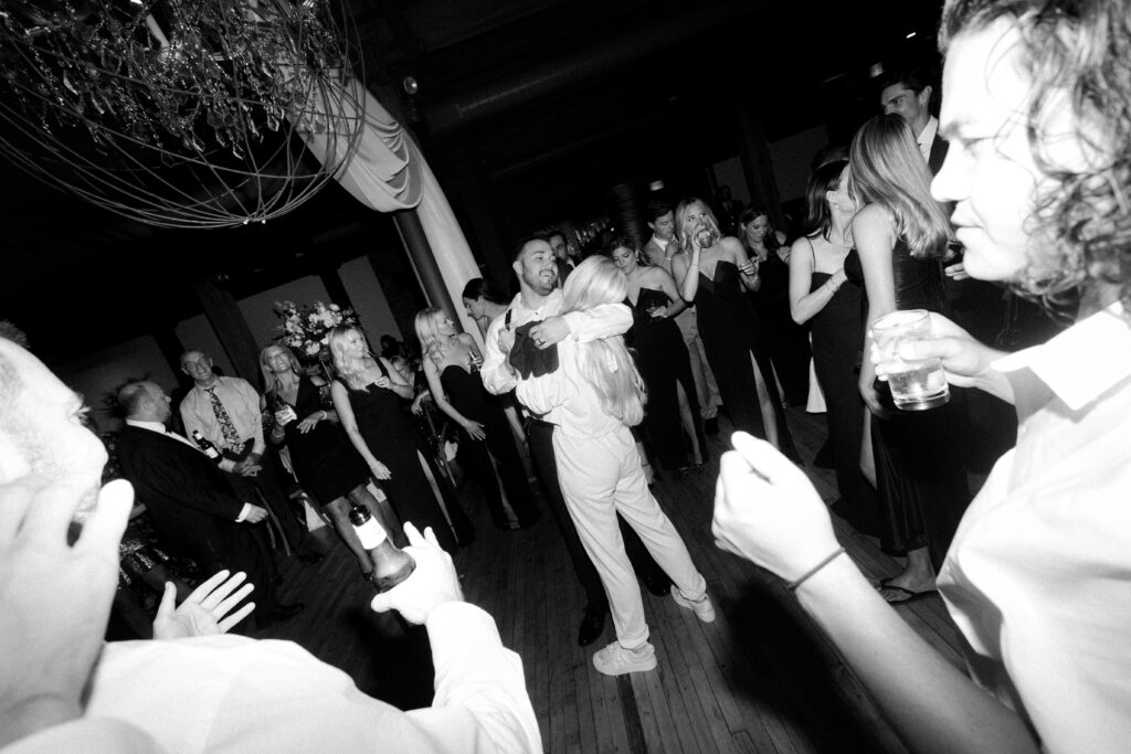 Bride and groom candid dancing moment during their wedding reception at Bridgeport Art Center in the Skyline Loft.