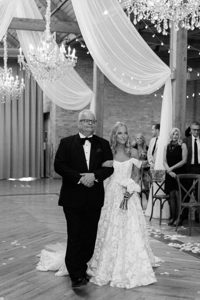 Bride being walked down the aisle at Bridgeport Art Center wedding.