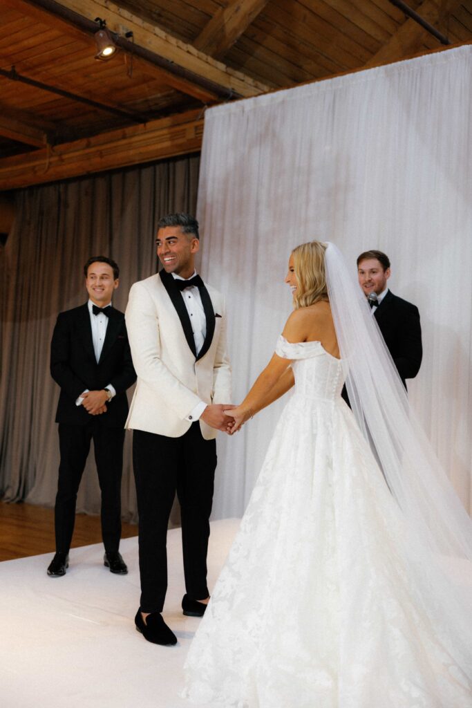 Bride and groom at their ceremony in the Skyline Loft at the Bridgeport Art Center.