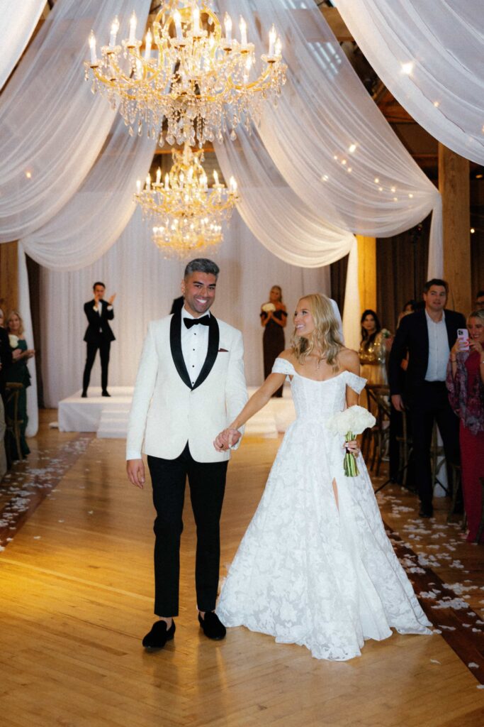 Bride and groom walking back down the aisle at their ceremony in the Skyline Loft at the Bridgeport Art Center.