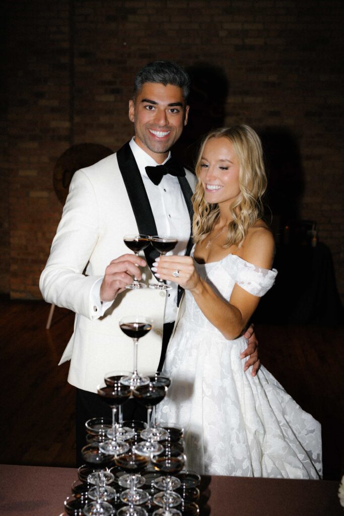 Bride and groom champagne tower during the reception of their wedding at Bridgeport Art Center in Chicago.