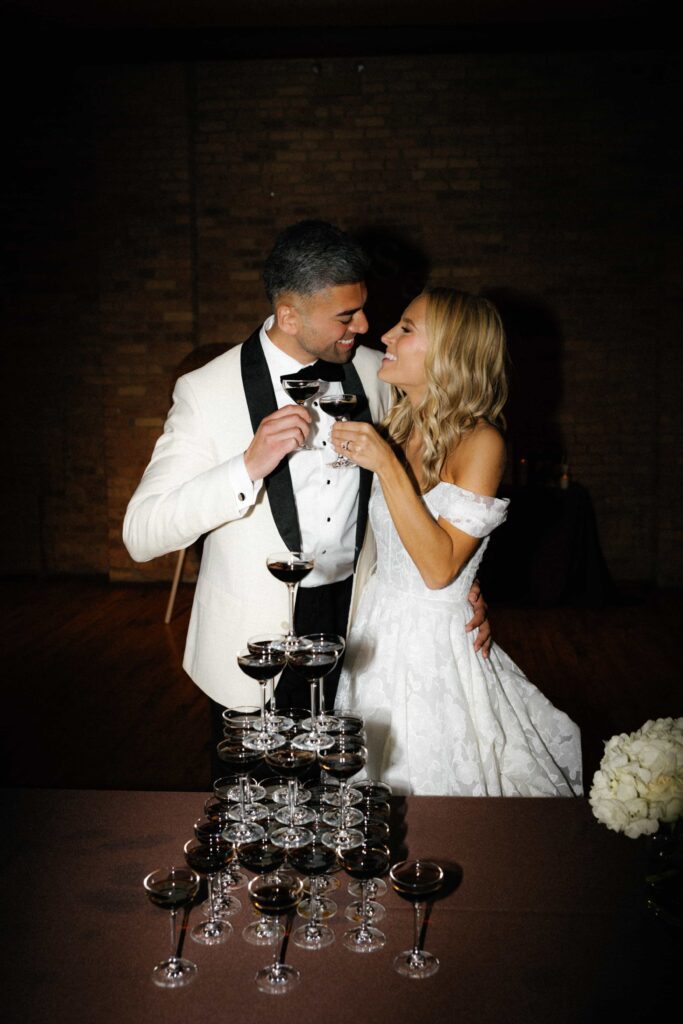 Bride and groom champagne tower during the reception of their wedding at Bridgeport Art Center in Chicago.