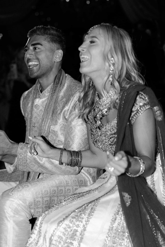 Bride and groom enjoying others dancing at their Chicago luxury wedding.