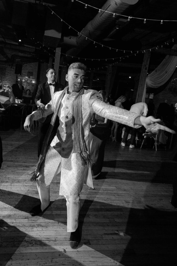 Groom dancing in black and white at his wedding reception at the Bridgeport Art Center.