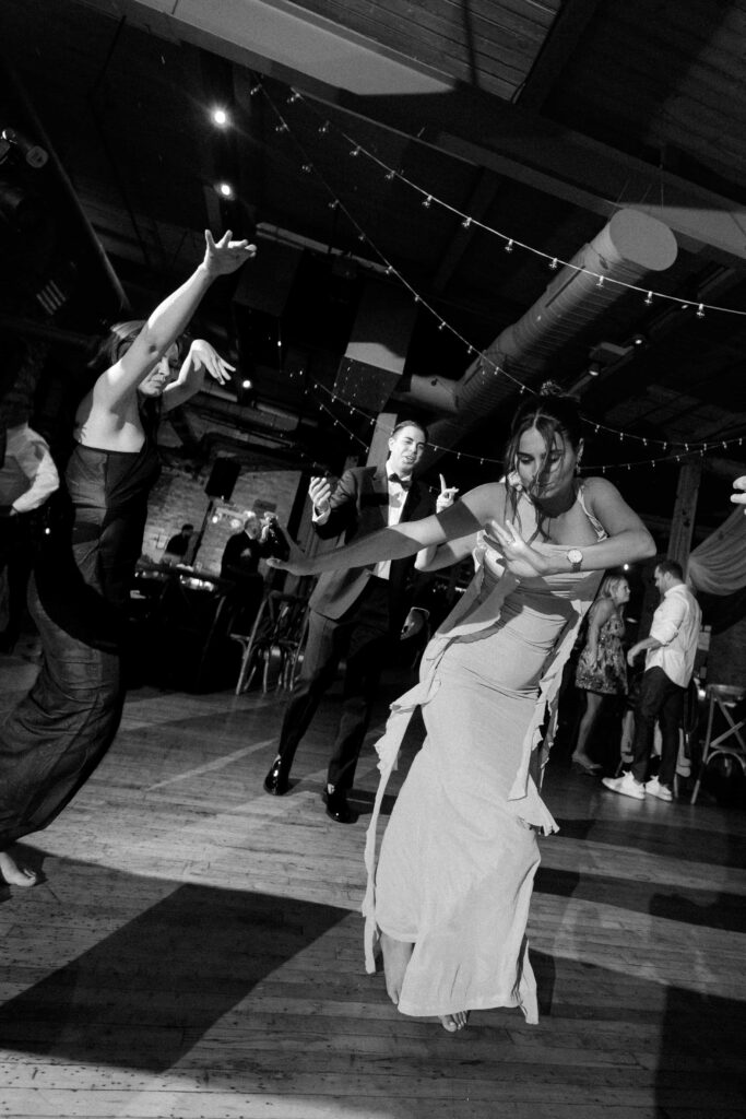 Wedding guests in black and white at his wedding reception at the Bridgeport Art Center.