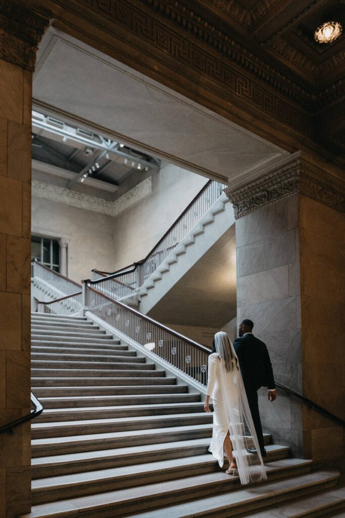 Bride and groom walking up stairs at the Art Institute of Chicago