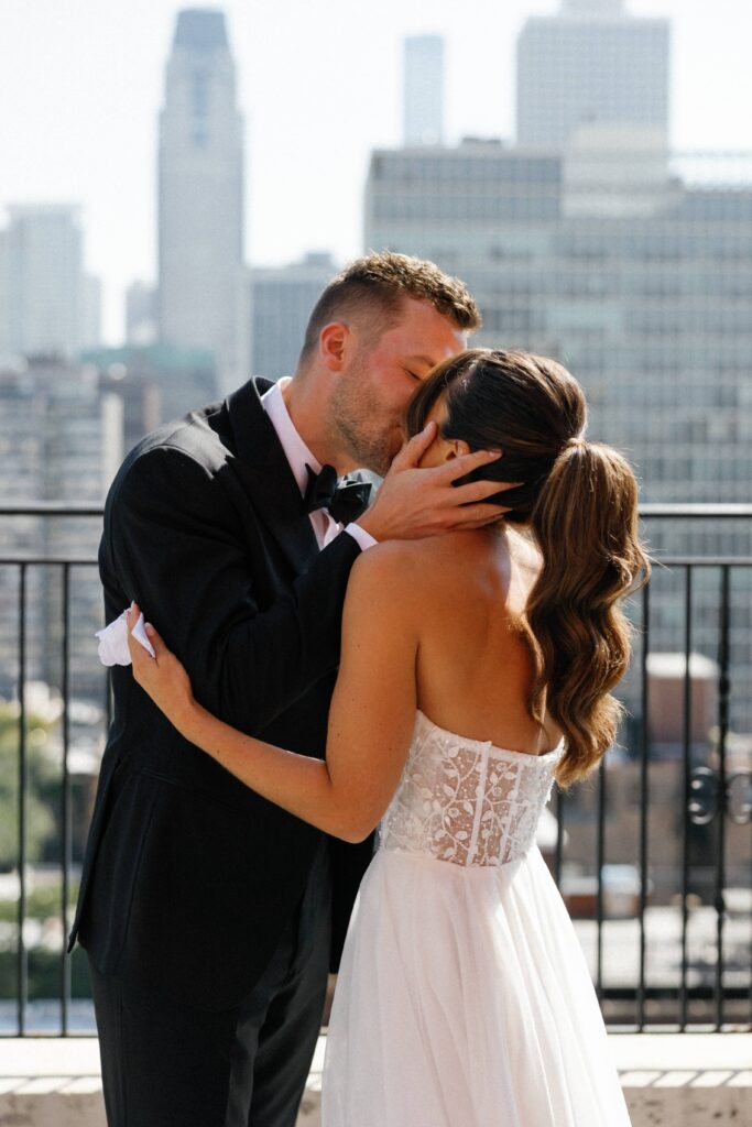 Bride and groom share a kiss at the first look before their Chicago wedding.