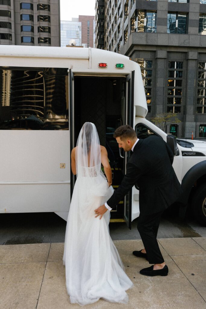 Bride and groom get on their Chicago wedding party bus.