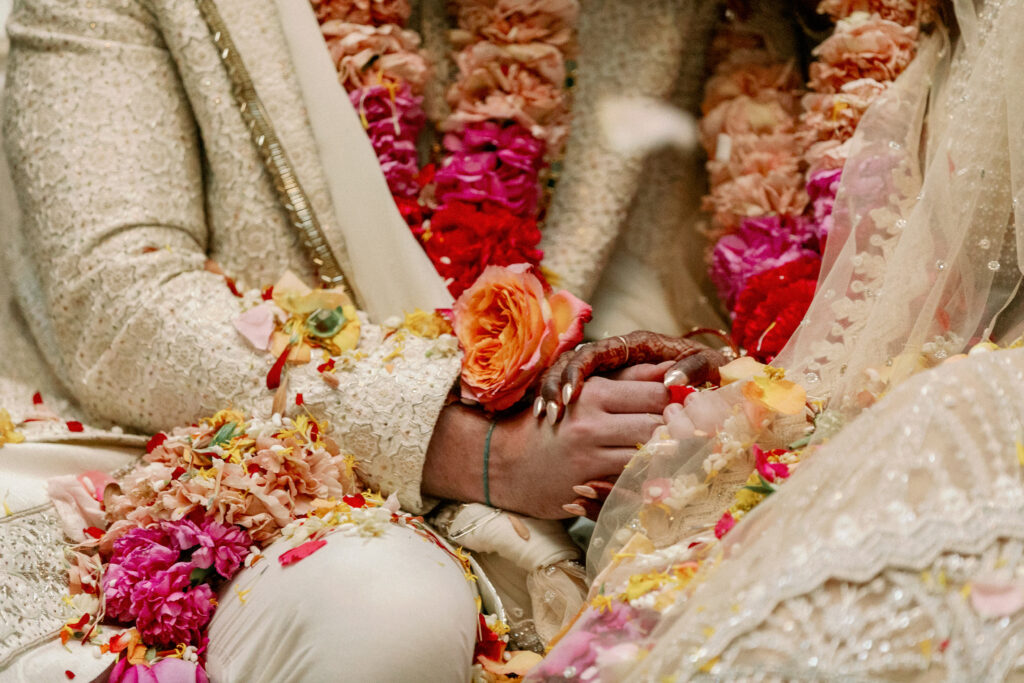 Bride and groom holding hands at Indian Chicago Cultural Center wedding