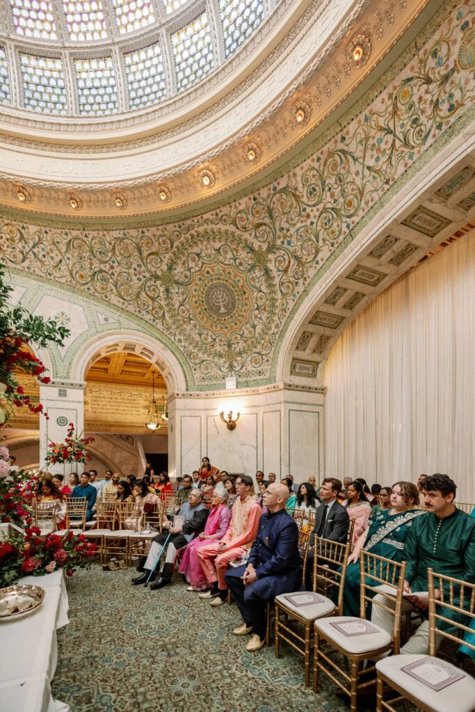 Wedding guests at an Indian wedding ceremony at the Chicago Cultural Center.