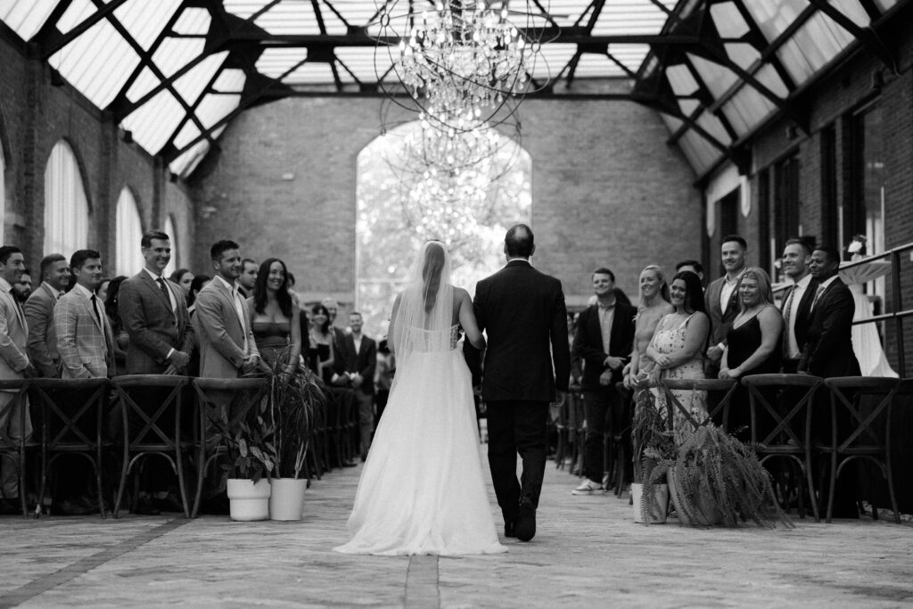 Bride walking the aisle in the Sculpture Garden at the Bridgeport Art Center wedding venue.