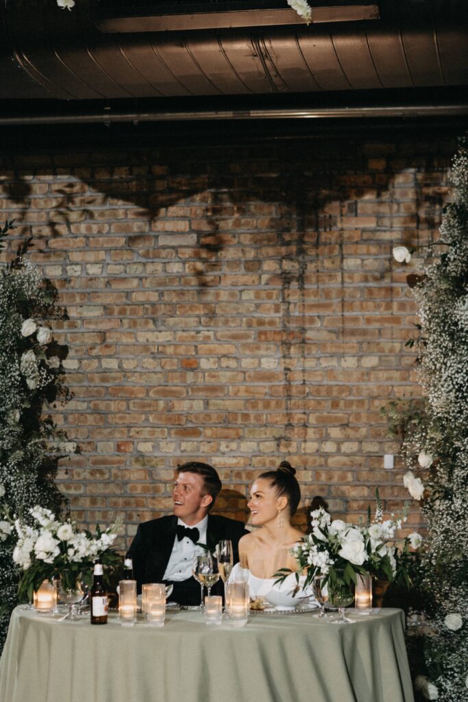 Bride and groom enjoying an emotional speech during their Revel Space wedding reception.