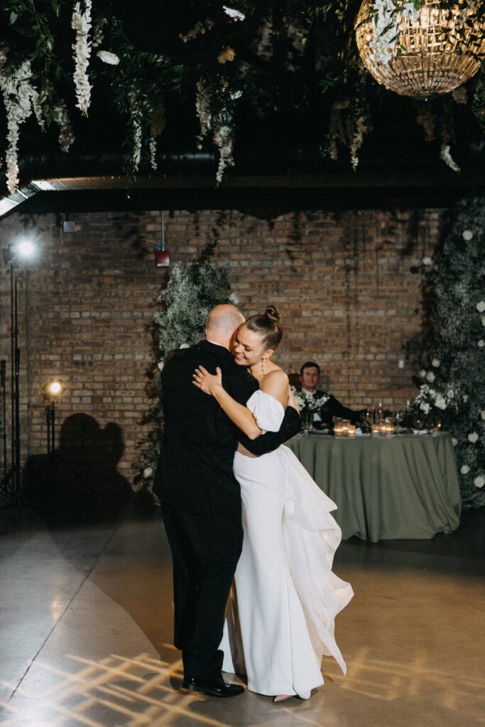 The bride and her father share a moment on the dance floor during their first dance.