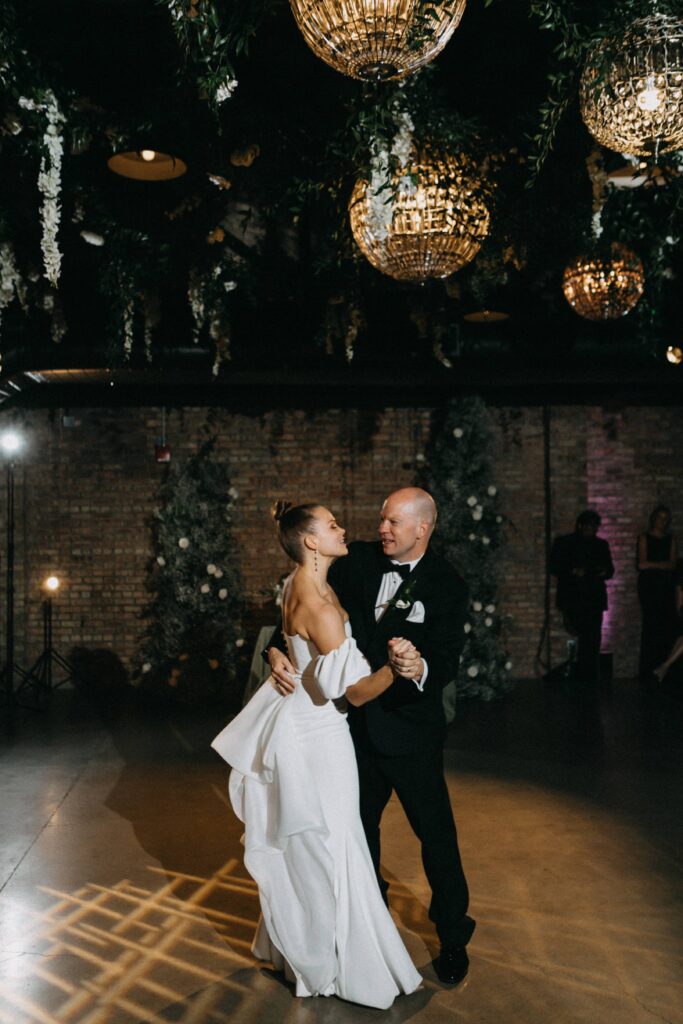 Bride and her father share a dance at the wedding reception held at Revel Space.