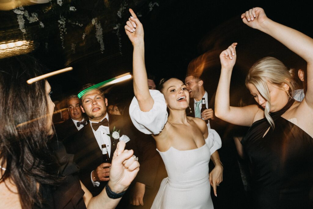 Candid photos of the bride dancing during her reception at Revel Motor Row.