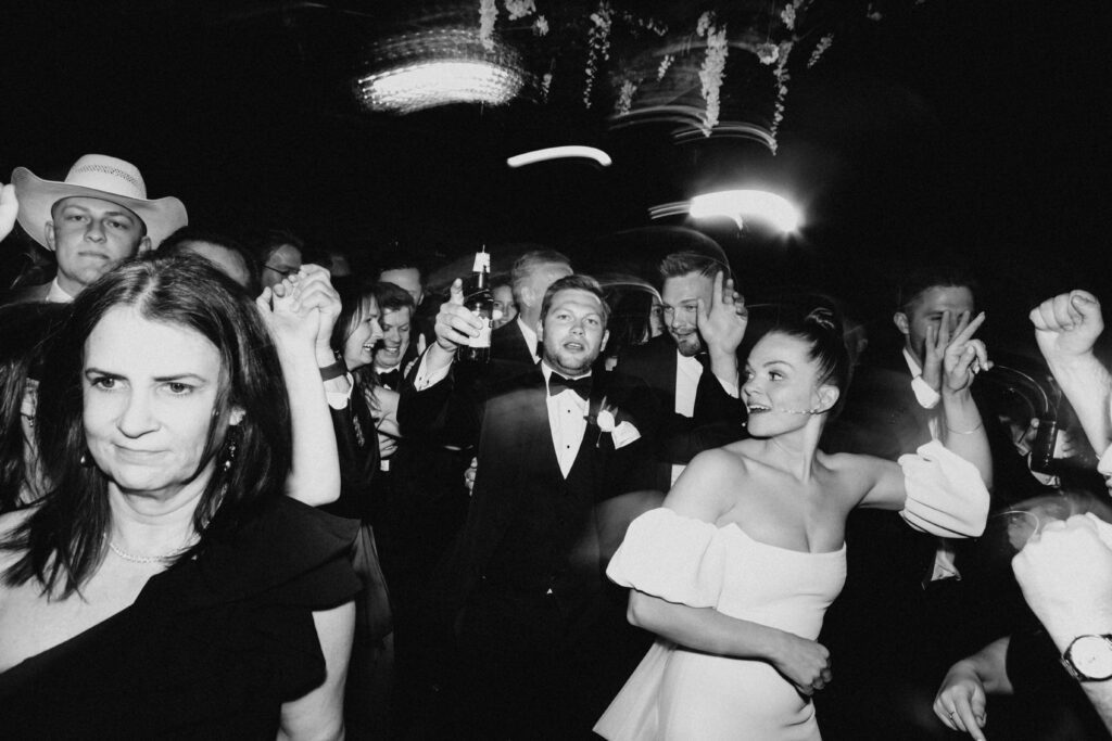 Black and white wedding photos on the dance floor at Revel Space.