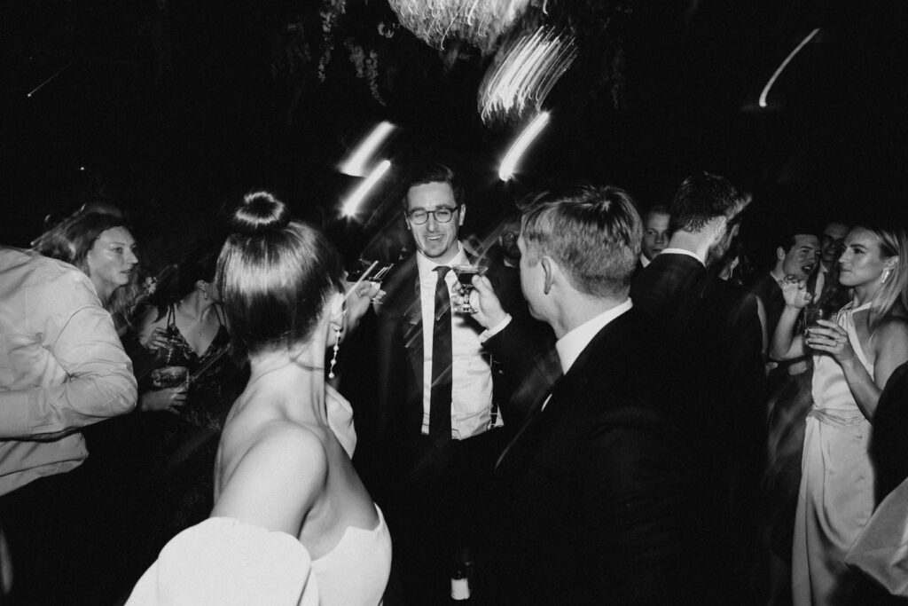 Bride and groom with guests on the dance floor at Revel Space.