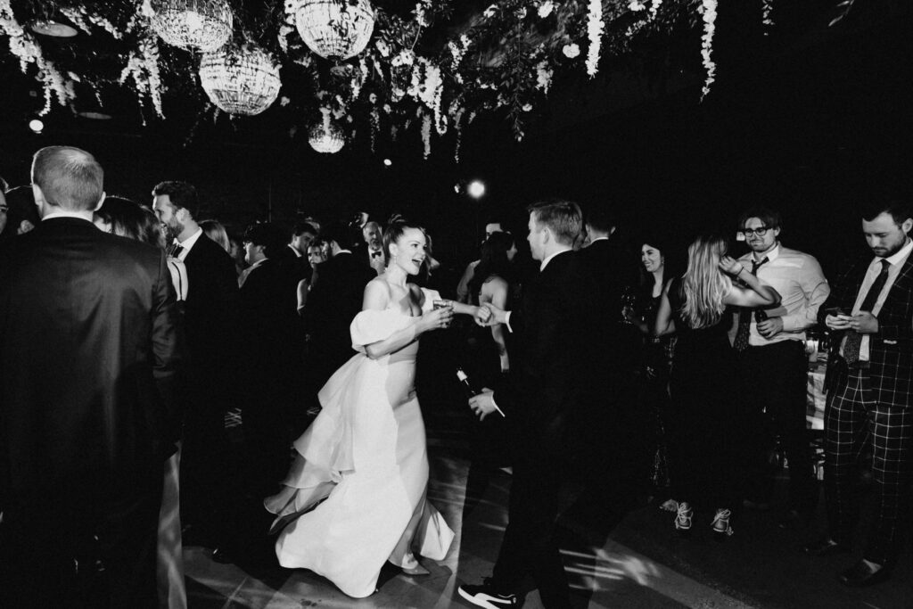 Black and white motion blur photos or a bride dancing on the dance floor at Revel Space.