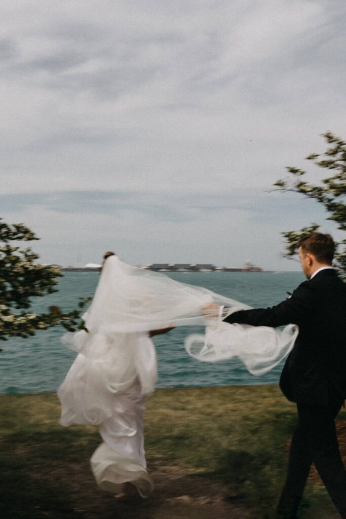 Motion blue editorial couple's portraits on their wedding day in Chicago, just off Lake Michigan