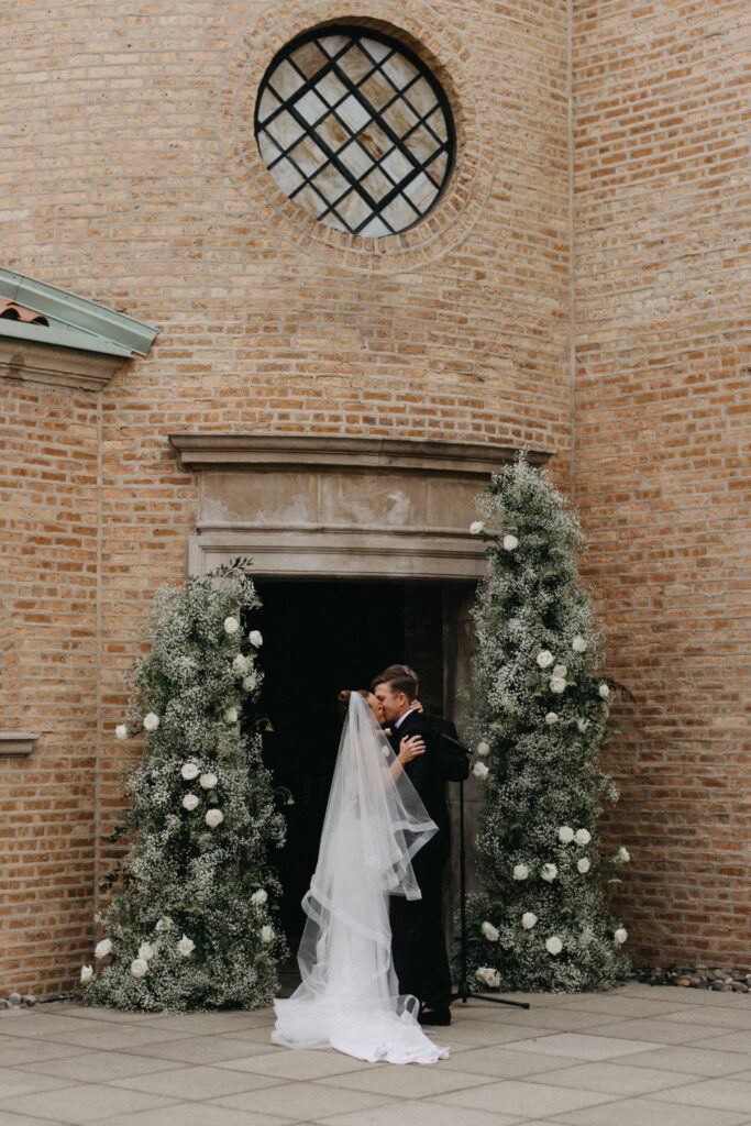 Bride and groom share their first kiss at Revel Space during the ceremony.