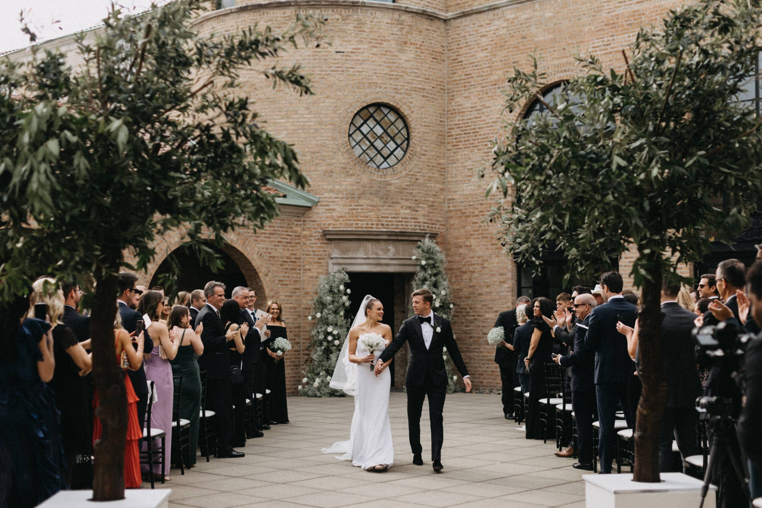 Bride and groom walking down the aisle for the first time as a married couple.