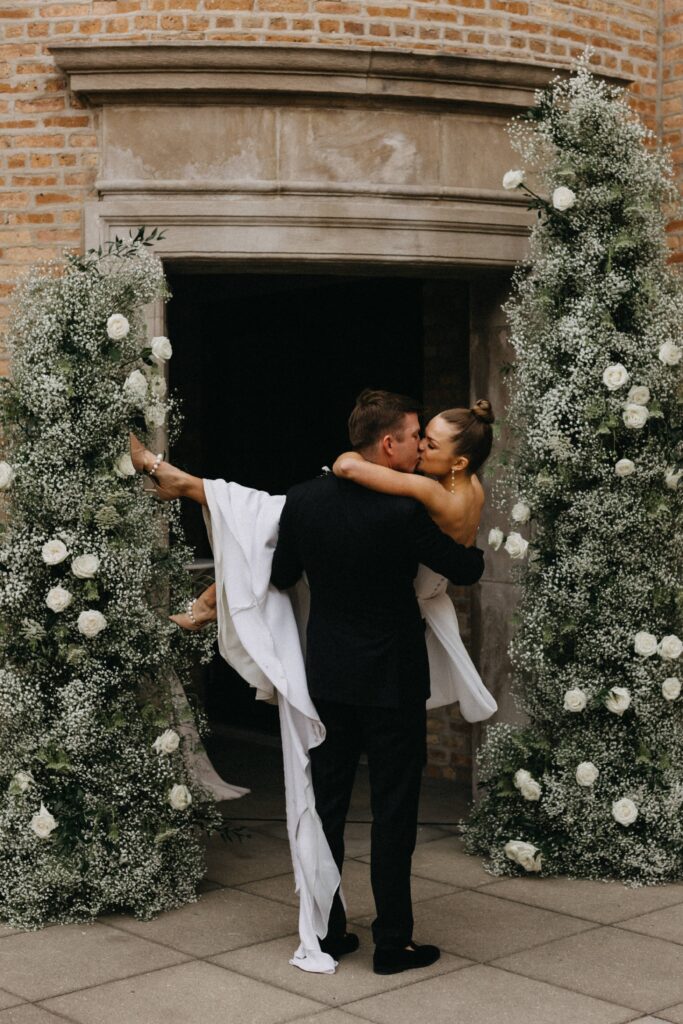 Bride and groom portraits as the share a kiss.