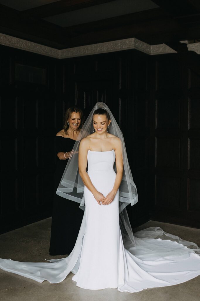 The bride and her mother share a sweet moment at her guest suite as she gets ready for her wedding.