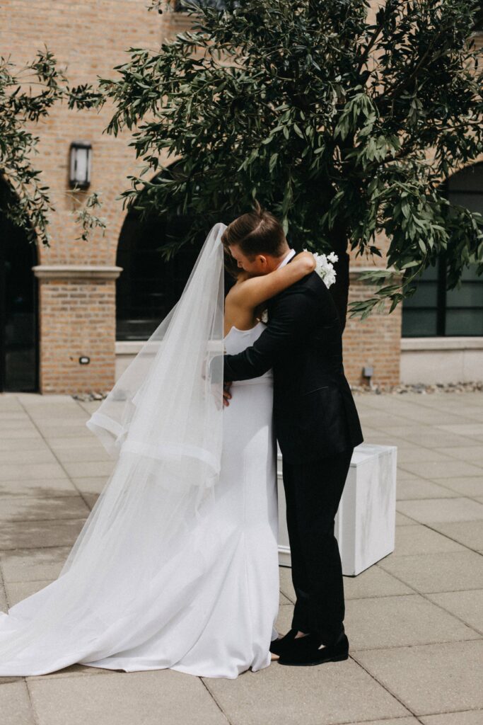 Bride and groom share a sweet moment before their reception at Revel Motor Row.