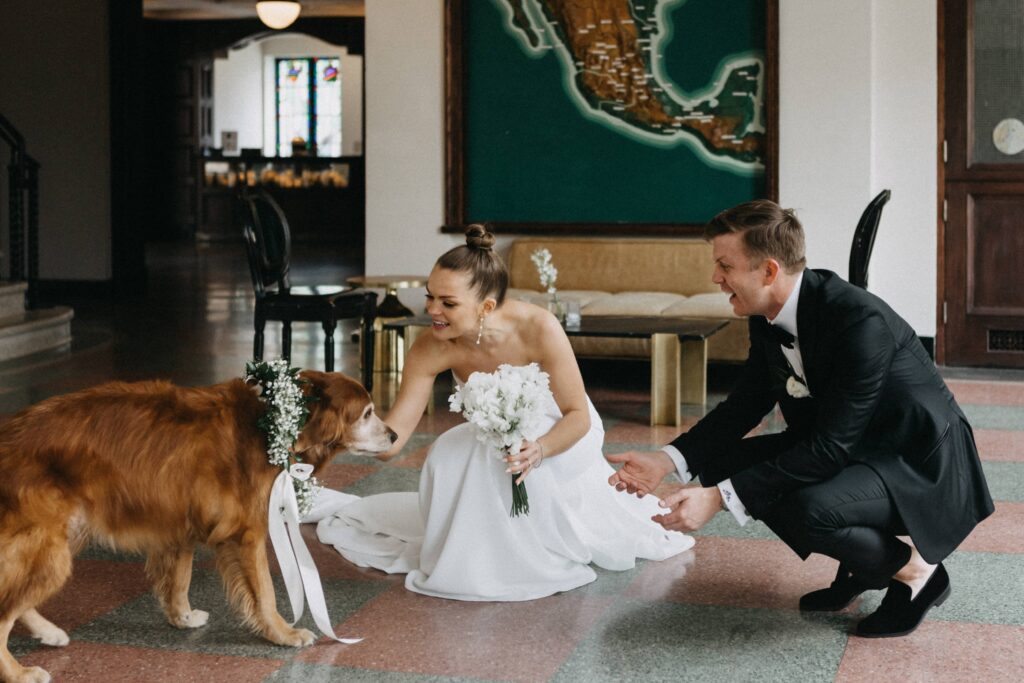 Bride, groom and their dog before their wedding ceremony.