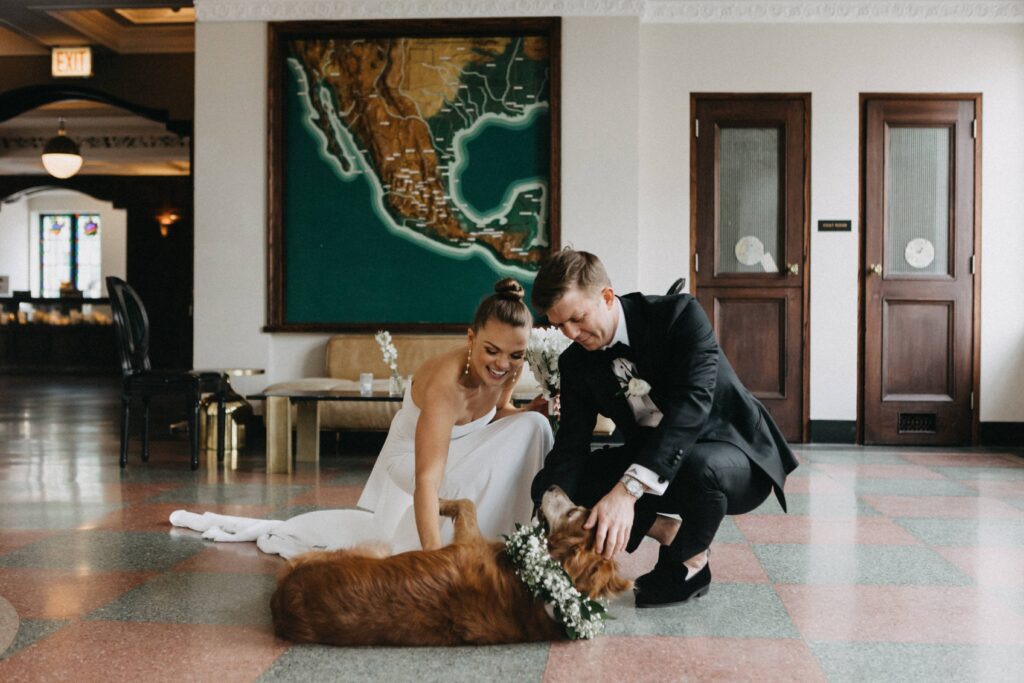 Bride, groom and their dog Honey enjoying some time together during the wedding day.