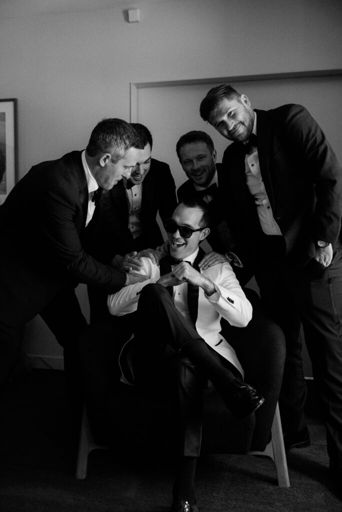 Groomsmen laugh together at The Old Post Office
