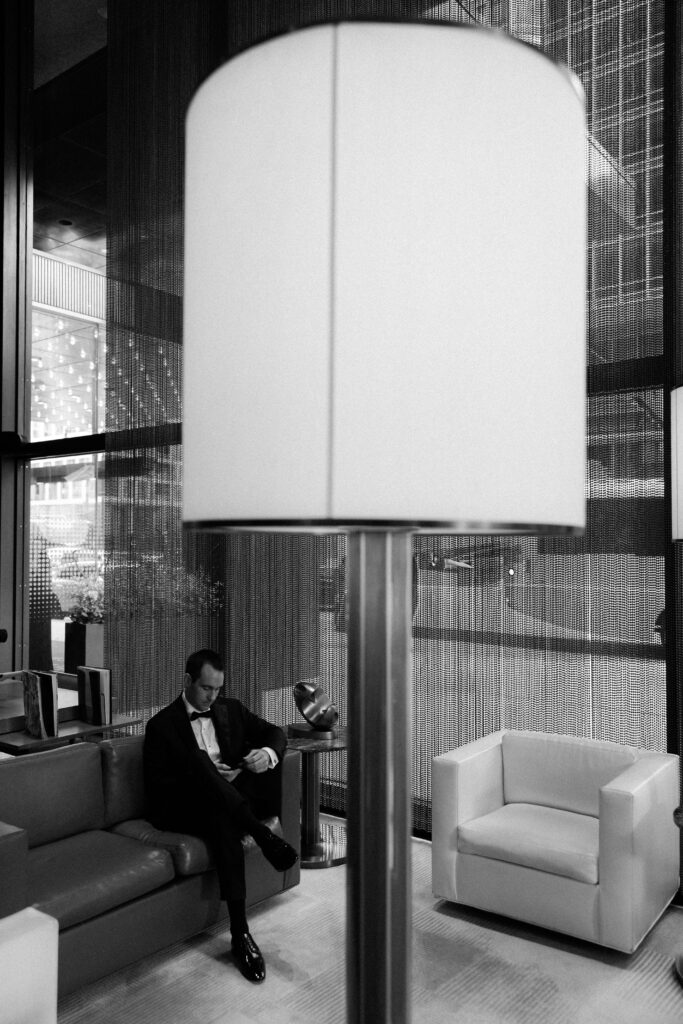 Groom gets ready in suite at The Old Post Office