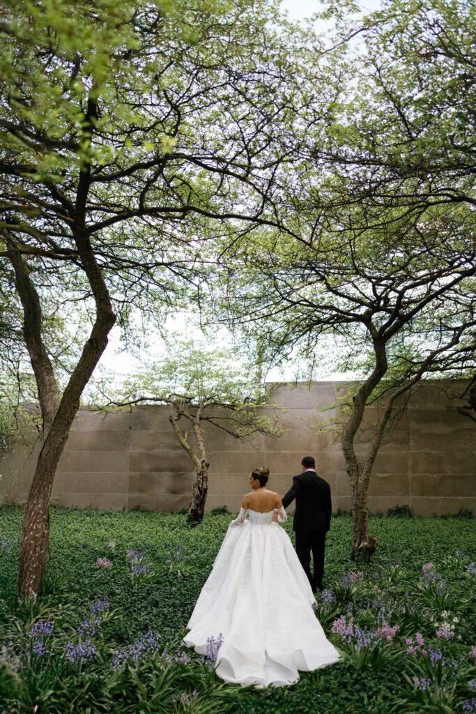 Bride and groom walk through park in downtown Chicago