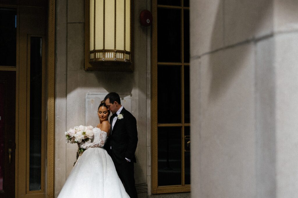 Wedding couple holds each other and poses in downtown Chicago
