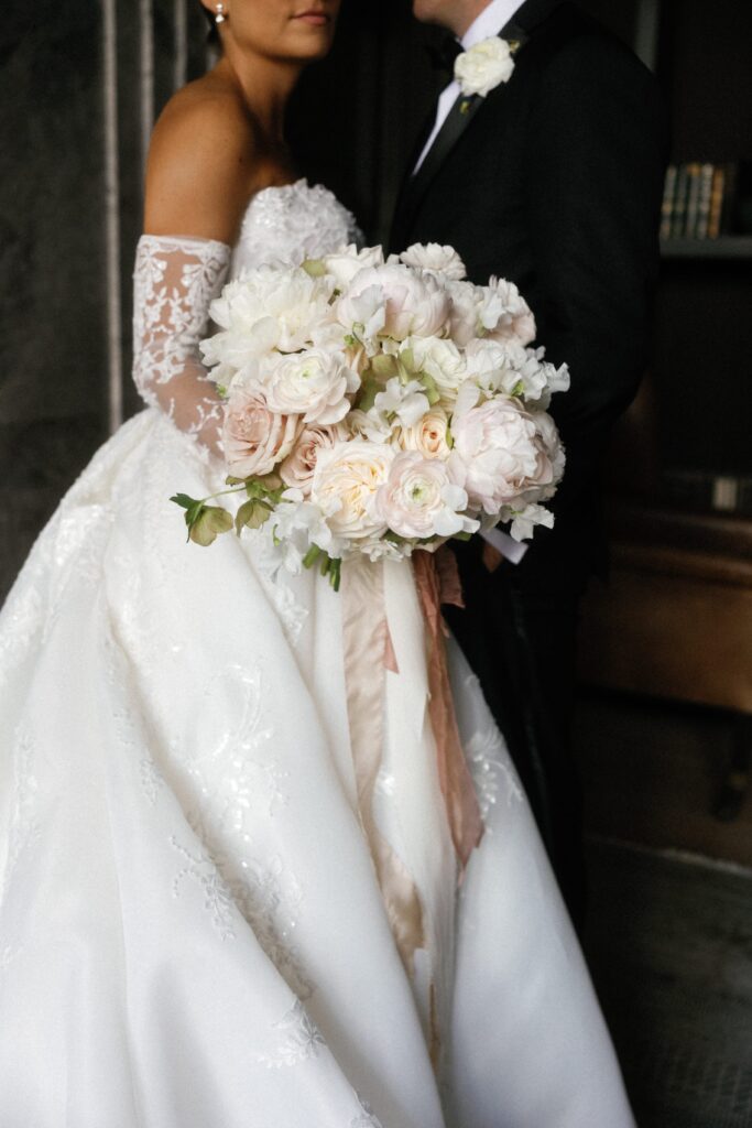 Bride and groom hold flowers and pose at The Old Post Office in Chicago