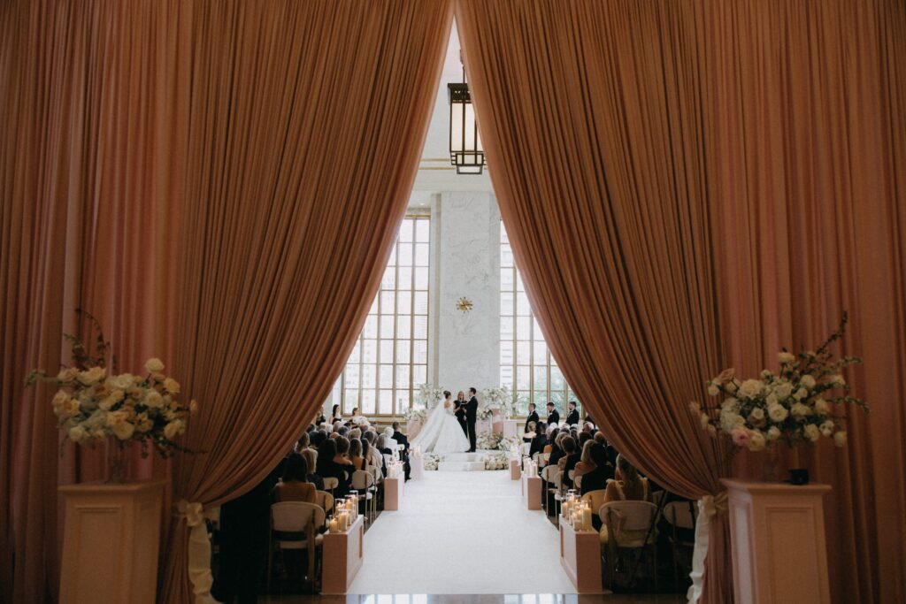 Couple holding hands in faraway shot at The Old Post Office wedding ceremony