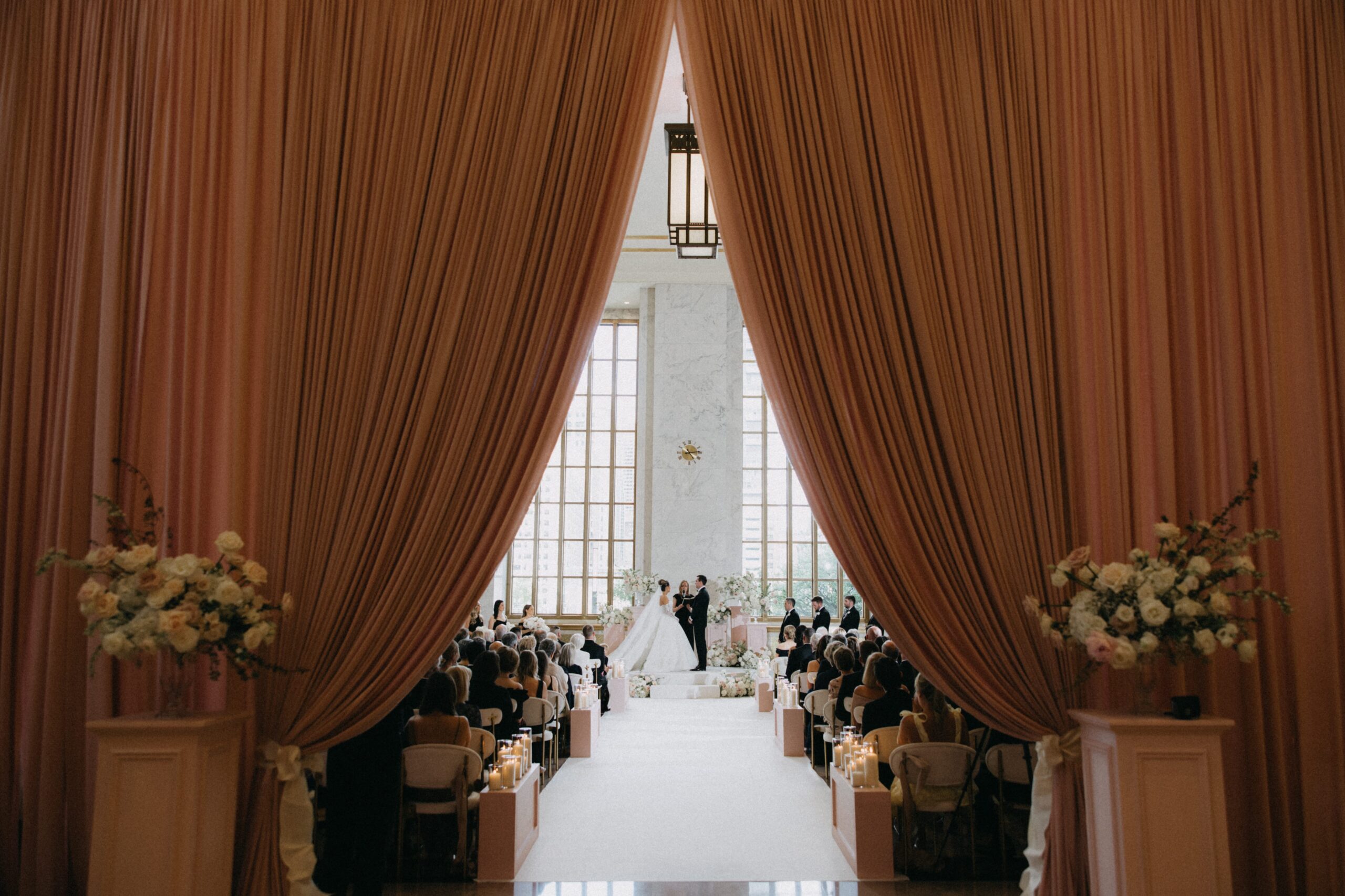 Couple holding hands in faraway shot at The Old Post Office wedding ceremony