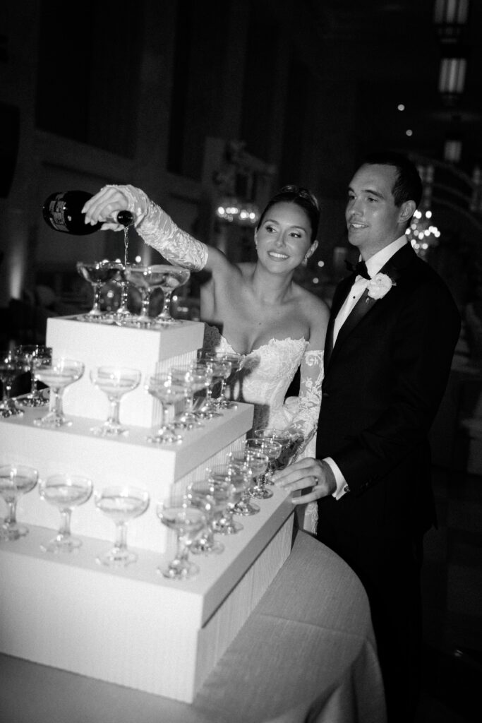 Couples pours champagne tower at The Old Post Office in Chicago