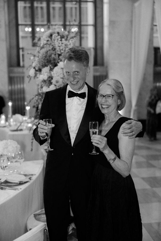 Couple smiles during wedding toasts at The Old Post Office