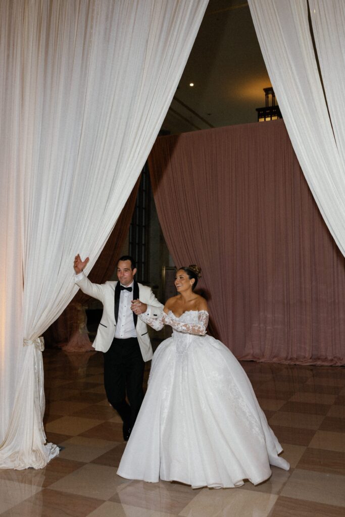 Couple enters their wedding reception at The Old Post Office