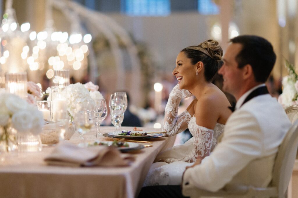 Couple laughing during speeches at their wedding reception at The Old Post Office