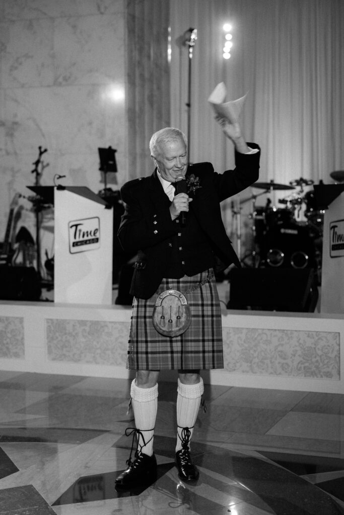Candid moment during wedding toasts at The Old Post Office