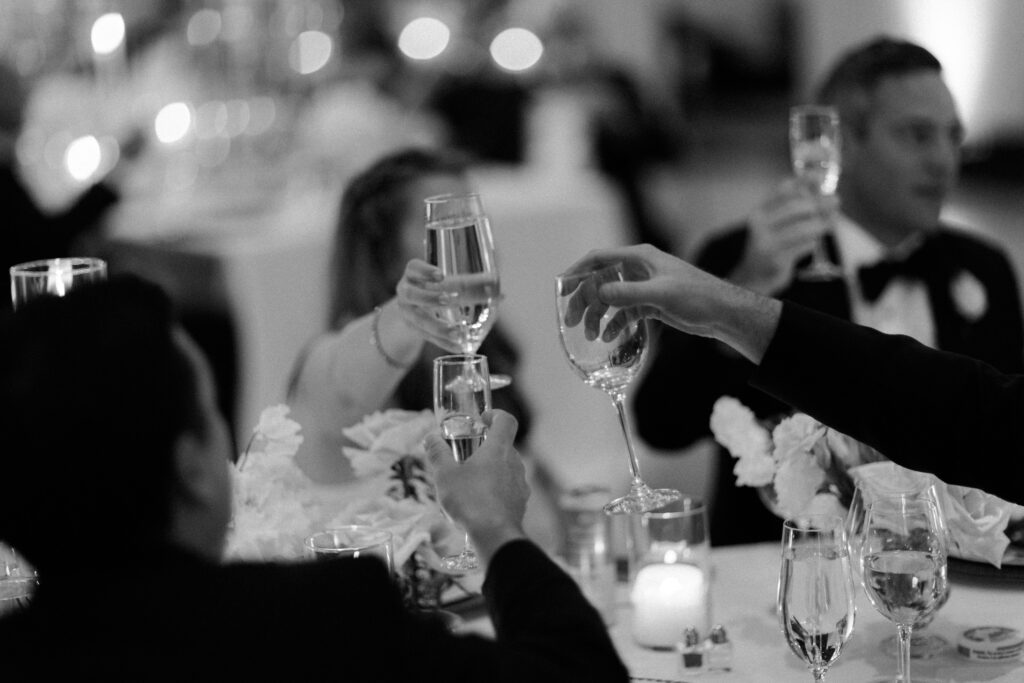 Guests clinking glasses during reception dinner