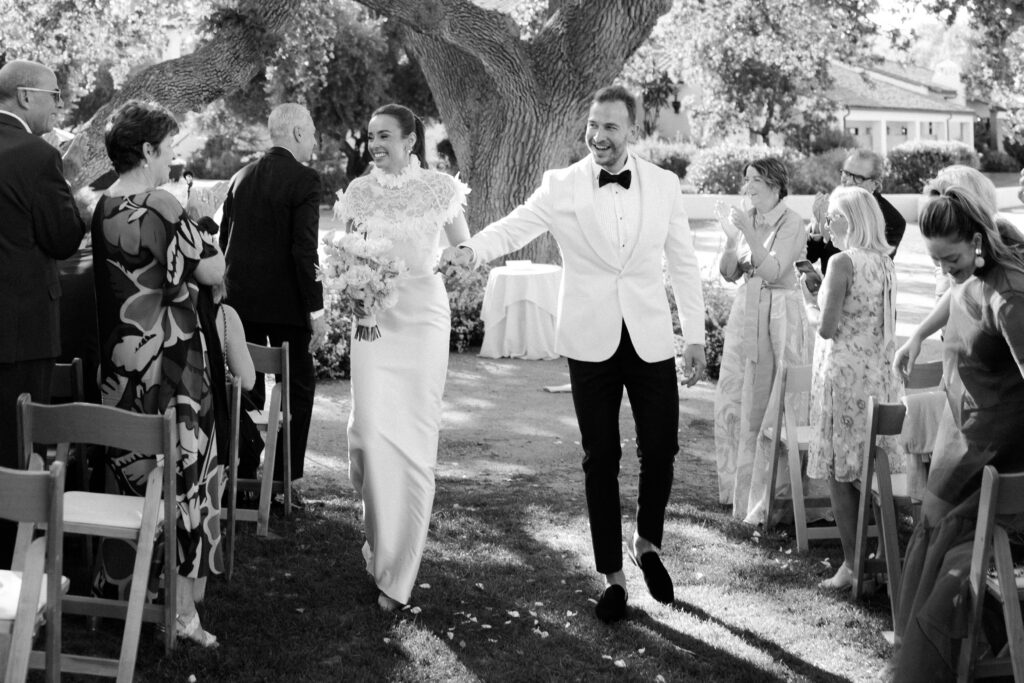Wedding couple exit their Artist Cottage Lawn wedding ceremony at Ojai Valley Inn