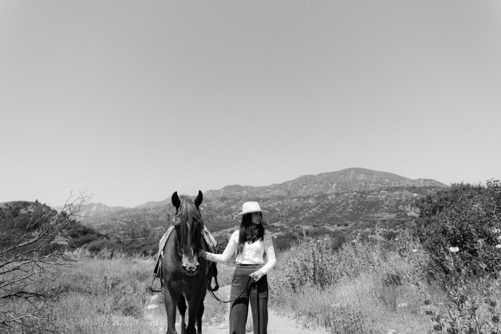 Bride rides a horse the day before her wedding at Ojai Valley Inn